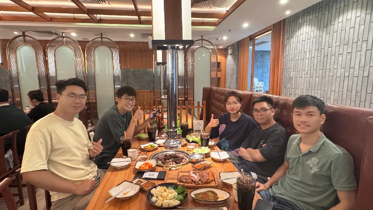 Enjoying a meal together with plates of grilled meat and side dishes