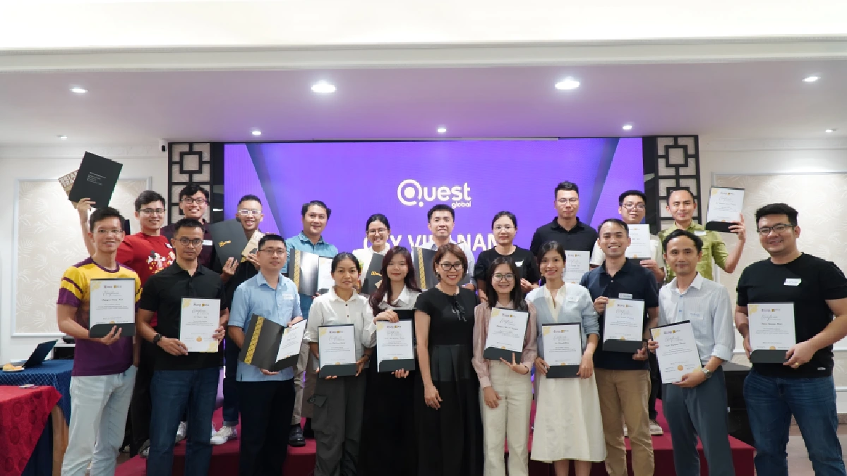 Group photo of team members holding certificates on stage
