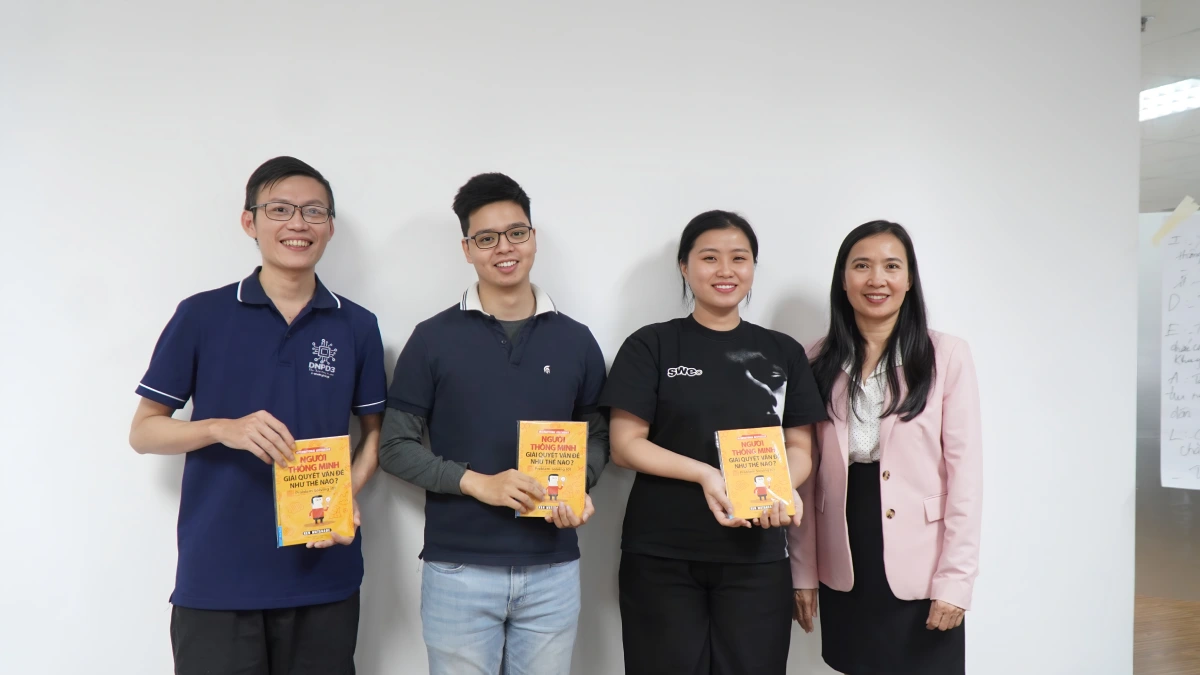 Group photo of team members holding books