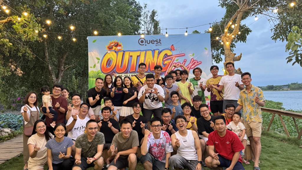 A group of people posing together during an outdoor outing event