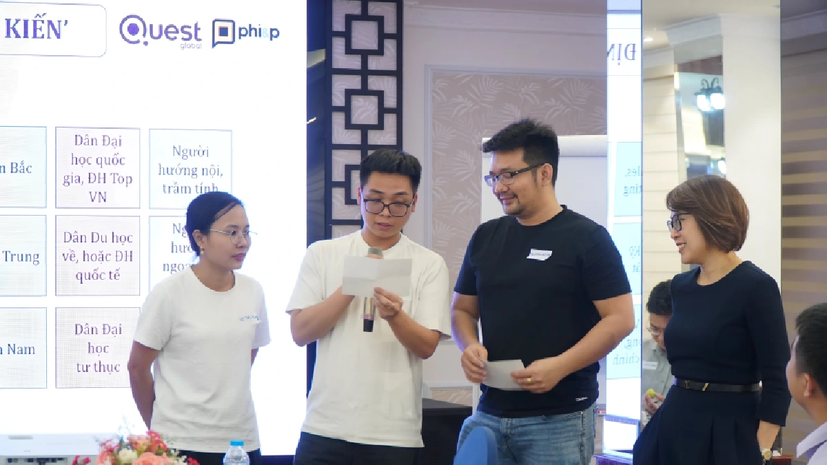 Team members standing and presenting during a group activity at a workshop